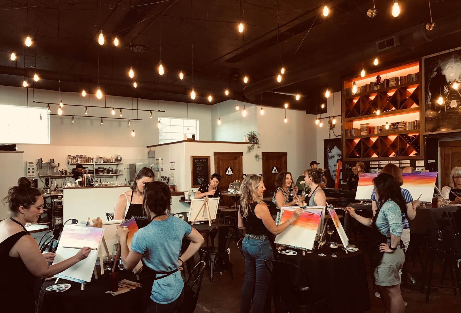 Friends painting and laughing at a Tahoe wine bar